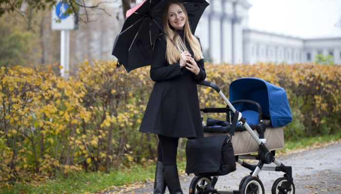 23139004 - mother with baby stroller for a newborn in autumn park